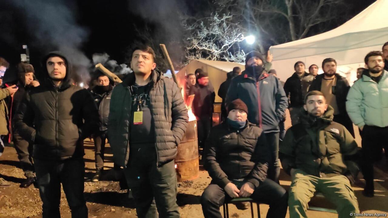 Участники акции протеста и миротворцы вместе смотрят футбольный матч Франция-Марокко